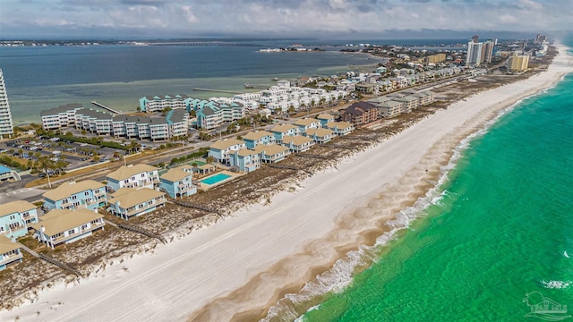 birds eye view of property featuring a beach view and a water view