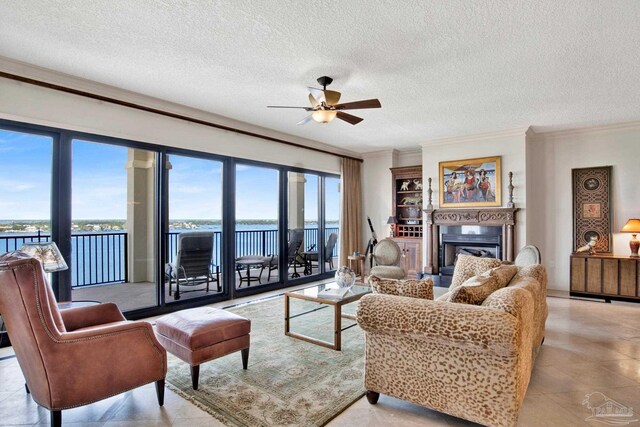 living room featuring crown molding, light tile patterned floors, a textured ceiling, a water view, and ceiling fan