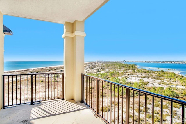 balcony featuring a beach view and a water view