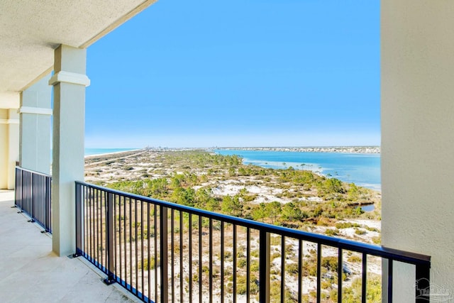 balcony featuring a beach view and a water view