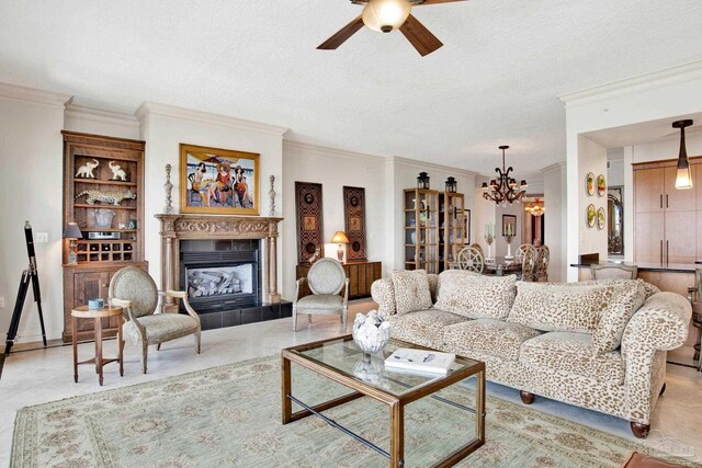 living room with a textured ceiling, ceiling fan with notable chandelier, ornamental molding, and light tile patterned floors