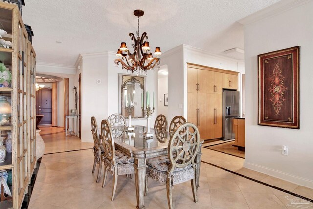 tiled dining space featuring an inviting chandelier, a textured ceiling, and ornamental molding