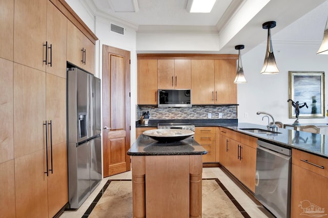 kitchen with tasteful backsplash, a kitchen island, stainless steel appliances, crown molding, and a sink