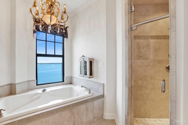 full bath featuring a chandelier, a stall shower, and a bath