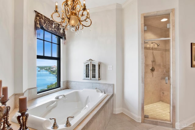 bathroom featuring ornamental molding, tile patterned floors, a garden tub, an inviting chandelier, and a shower stall