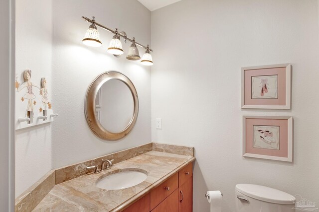 bathroom featuring vanity and toilet