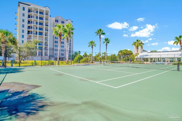 view of tennis court featuring fence