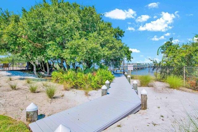 view of property's community featuring a dock and a water view