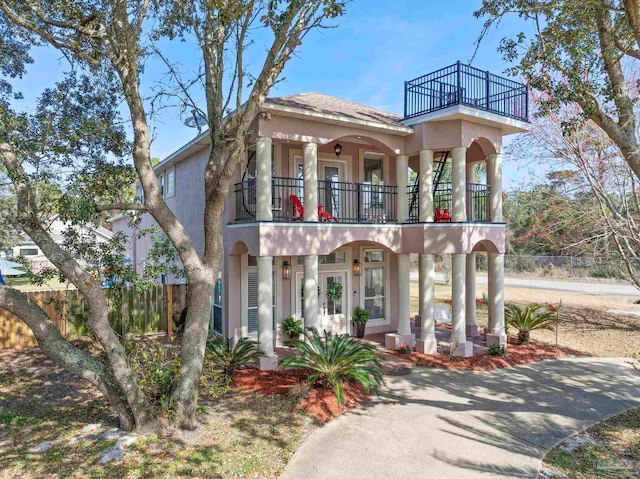 1669 Tidewater Ln, Navarre, FL 32566 - mediterranean / spanish home featuring a balcony, stucco siding, and a porch
