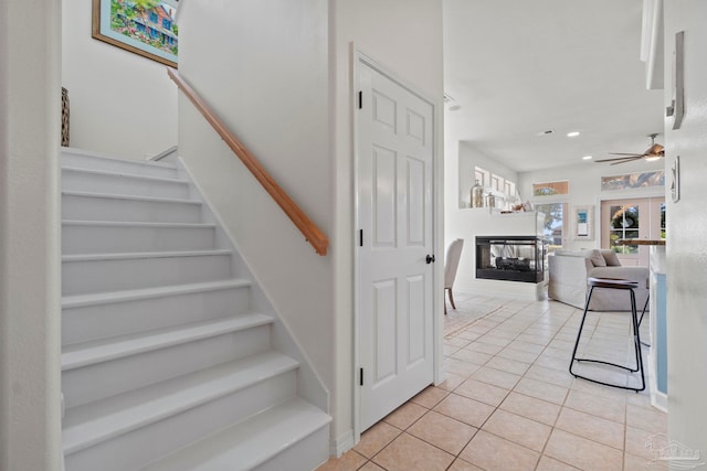 1669 Tidewater Ln, Navarre, FL 32566 - staircase with tile patterned flooring, a multi sided fireplace, recessed lighting, and ceiling fan