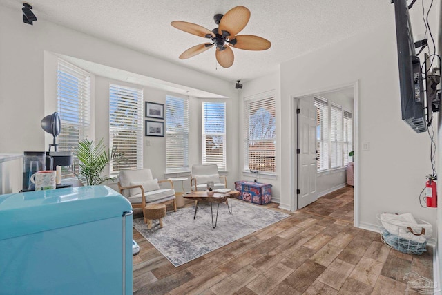 1669 Tidewater Ln, Navarre, FL 32566 - sitting room featuring ceiling fan, a textured ceiling, and wood finished floors