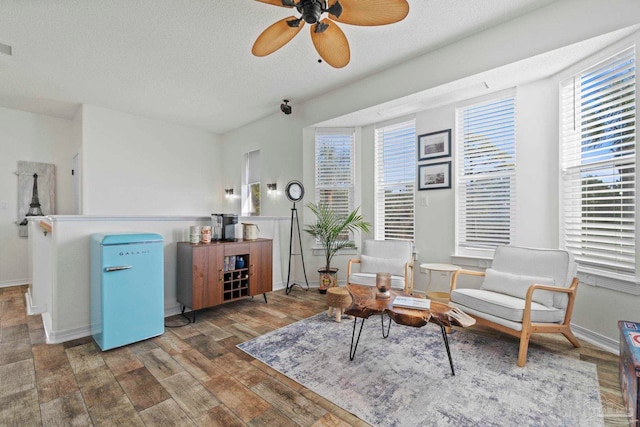 1669 Tidewater Ln, Navarre, FL 32566 - sitting room featuring wood finished floors, a ceiling fan, and a textured ceiling