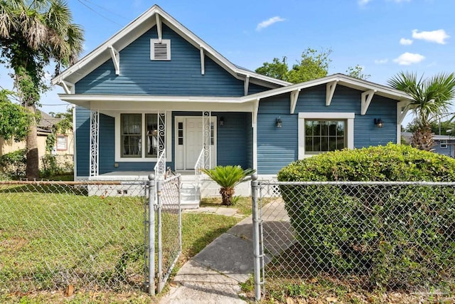 506 E Scott St, Pensacola, FL 32503 - bungalow-style home featuring a gate, a front lawn, a fenced front yard, and covered porch