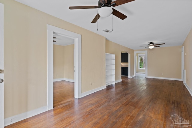 506 E Scott St, Pensacola, FL 32503 - unfurnished living room with wood-type flooring, arched walkways, a ceiling fan, baseboards, and visible vents