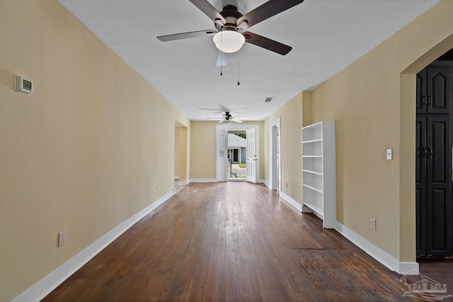 506 E Scott St, Pensacola, FL 32503 - unfurnished living room with baseboards, dark wood finished floors, ceiling fan, and visible vents