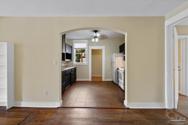 506 E Scott St, Pensacola, FL 32503 - kitchen featuring ceiling fan, white appliances, arched walkways, dark wood finished floors, and baseboards