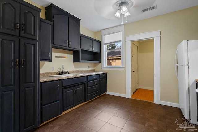 506 E Scott St, Pensacola, FL 32503 - kitchen featuring ceiling fan, a sink, light countertops, freestanding refrigerator, and visible vents