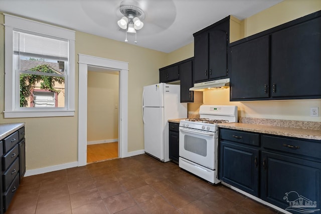 506 E Scott St, Pensacola, FL 32503 - kitchen with white appliances, baseboards, light countertops, under cabinet range hood, and a ceiling fan
