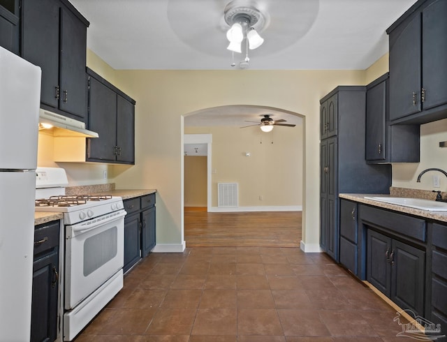 506 E Scott St, Pensacola, FL 32503 - kitchen with ceiling fan, a sink, white appliances, under cabinet range hood, and visible vents