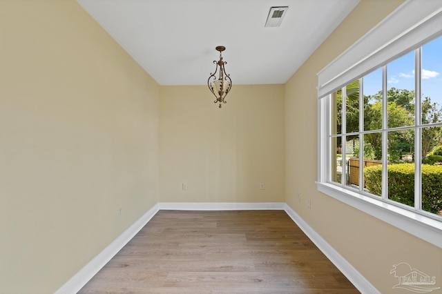 506 E Scott St, Pensacola, FL 32503 - spare room with visible vents, baseboards, wood finished floors, and a healthy amount of sunlight