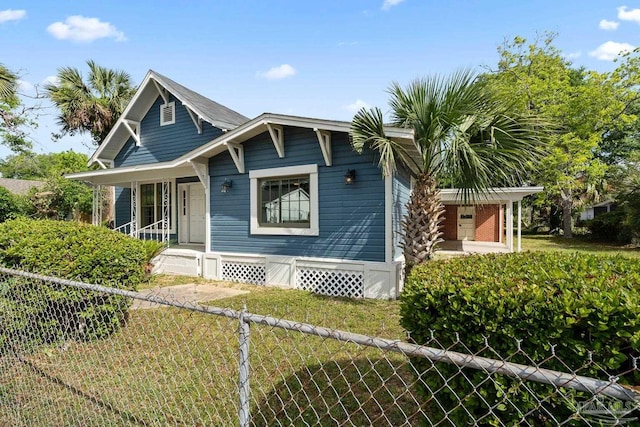 506 E Scott St, Pensacola, FL 32503 - bungalow-style home featuring a porch, a front yard, and fence private yard