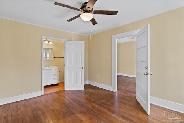 506 E Scott St, Pensacola, FL 32503 - unfurnished bedroom with ensuite bathroom, a sink, baseboards, wood-type flooring, and ornamental molding