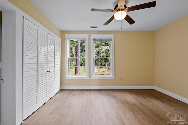 506 E Scott St, Pensacola, FL 32503 - unfurnished bedroom with baseboards, a closet, wood finished floors, and visible vents