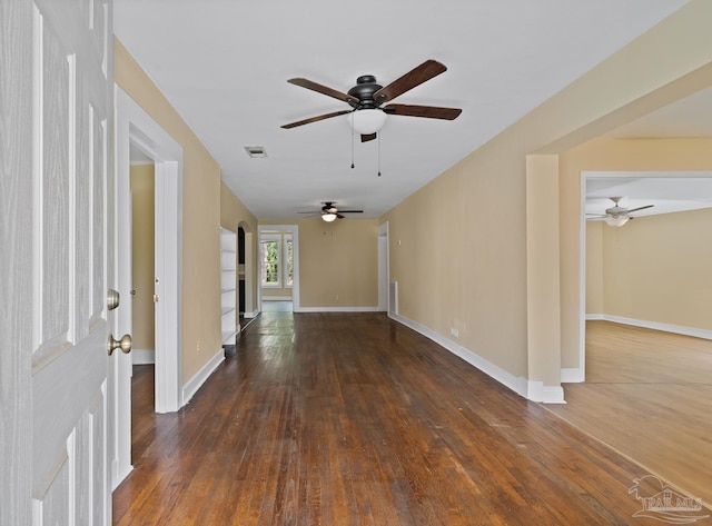 506 E Scott St, Pensacola, FL 32503 - spare room featuring dark wood-style flooring, ceiling fan, visible vents, and baseboards
