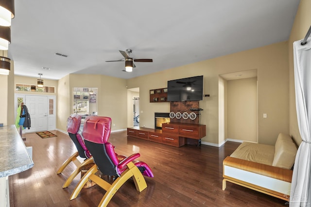7770 Fenwick St, Navarre, FL 32566 - living area featuring ceiling fan, dark wood-style floors, and a glass covered fireplace