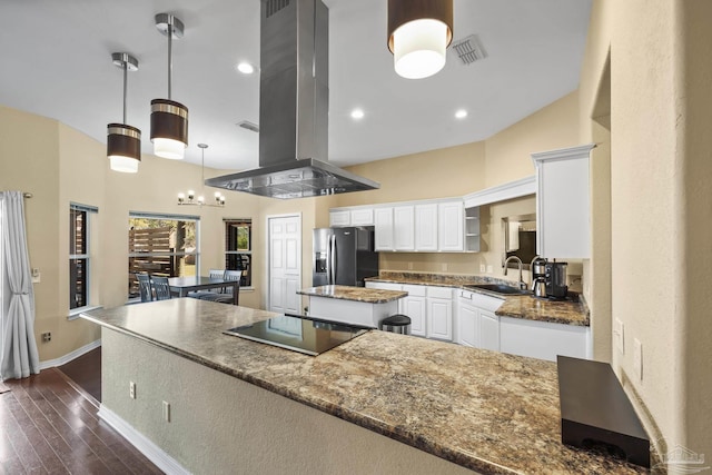 7770 Fenwick St, Navarre, FL 32566 - kitchen featuring stainless steel refrigerator with ice dispenser, a kitchen island, island exhaust hood, black electric stovetop, and white cabinets