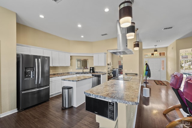 7770 Fenwick St, Navarre, FL 32566 - kitchen featuring refrigerator with ice dispenser, a kitchen island, dark wood finished floors, white cabinetry, and island range hood