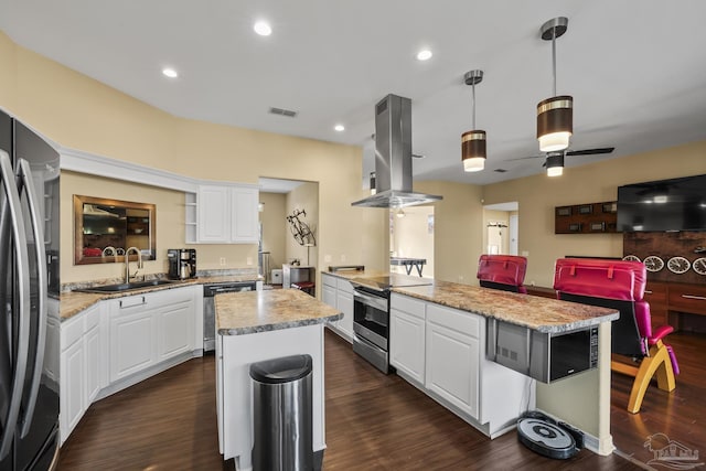 7770 Fenwick St, Navarre, FL 32566 - kitchen featuring appliances with stainless steel finishes, island range hood, dark wood-style floors, white cabinets, and a peninsula