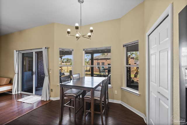 7770 Fenwick St, Navarre, FL 32566 - dining area featuring a chandelier, wood finished floors, and a towering ceiling