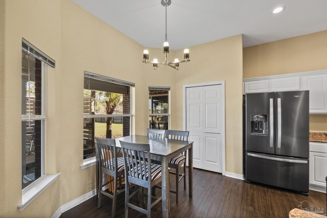 7770 Fenwick St, Navarre, FL 32566 - dining room featuring a chandelier, dark wood-type flooring, and recessed lighting