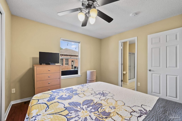 7770 Fenwick St, Navarre, FL 32566 - bedroom with wood finished floors, ceiling fan, and a textured ceiling