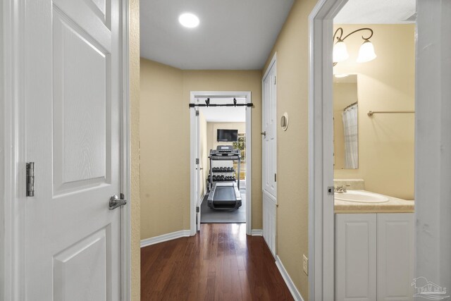 7770 Fenwick St, Navarre, FL 32566 - hall with a sink and dark wood-style flooring