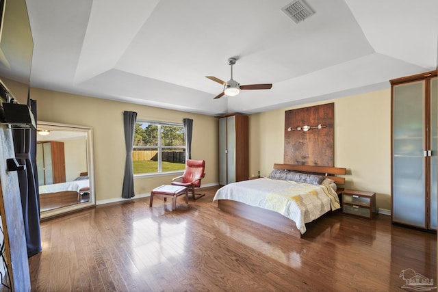 7770 Fenwick St, Navarre, FL 32566 - bedroom with a raised ceiling, wood finished floors, and a ceiling fan