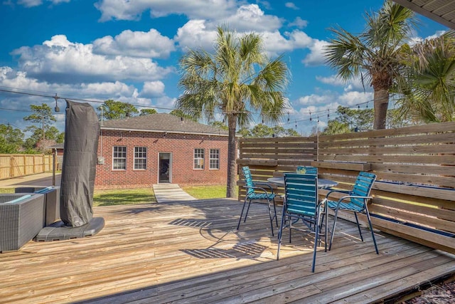 7770 Fenwick St, Navarre, FL 32566 - wooden terrace with outdoor dining area