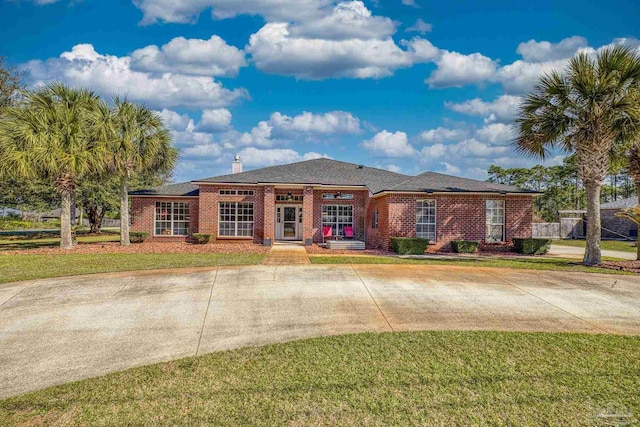 7770 Fenwick St, Navarre, FL 32566 - view of front facade featuring brick siding and a front yard