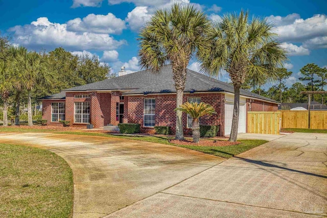7770 Fenwick St, Navarre, FL 32566 - view of front of home with concrete driveway, a garage, brick siding, and a shingled roof