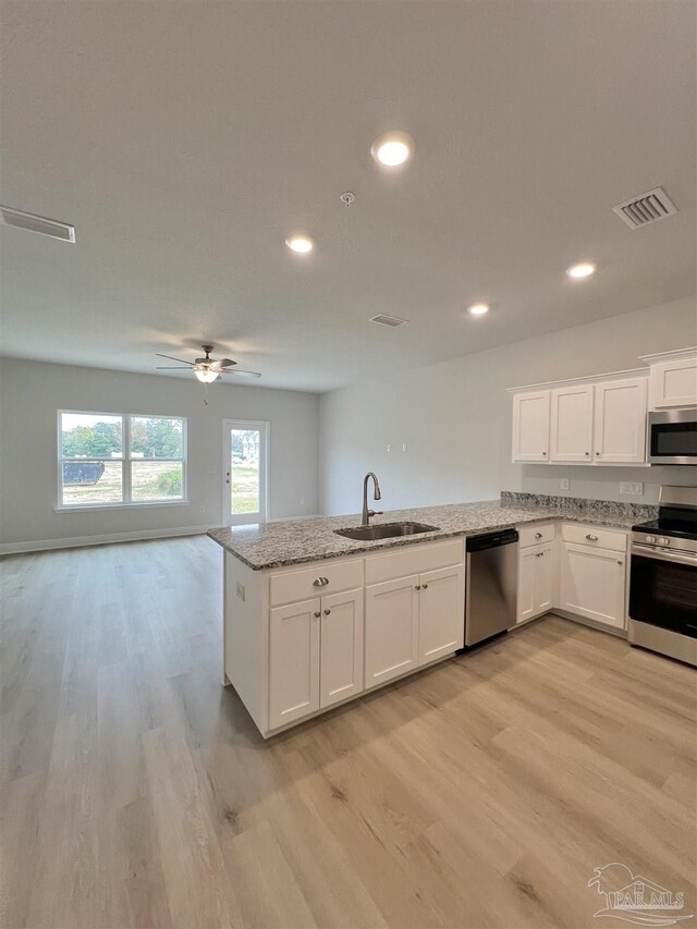 6036 Brylex Ln Unit 19A, Pensacola, FL 32526 - kitchen featuring white cabinetry, sink, light stone countertops, and appliances with stainless steel finishes