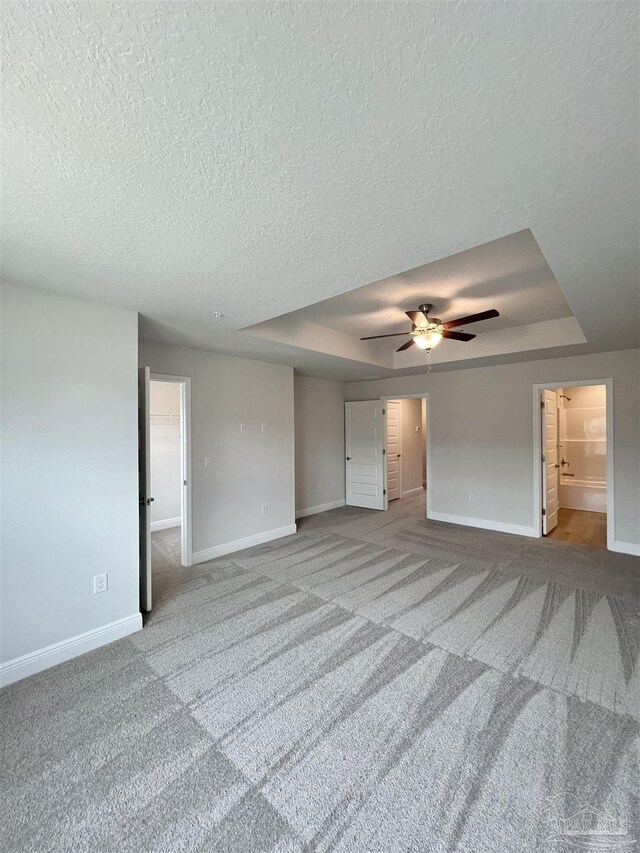 6036 Brylex Ln Unit 19A, Pensacola, FL 32526 - unfurnished room featuring ceiling fan, carpet flooring, a textured ceiling, and a tray ceiling