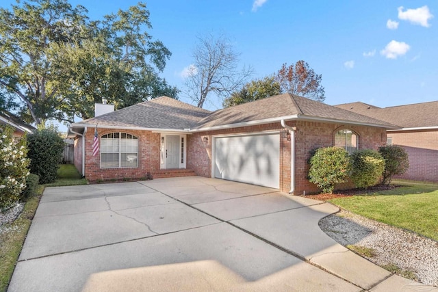 ranch-style house featuring a front lawn and a garage