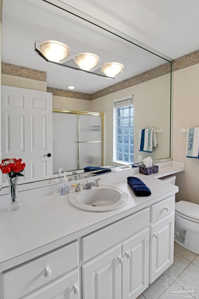 5140 Grumann Dr, Pensacola, FL 32507 - bathroom with a shower stall, tile patterned floors, vanity, and toilet