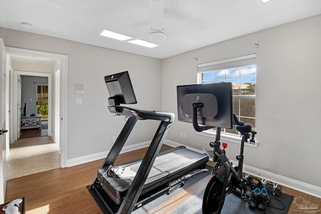 5140 Grumann Dr, Pensacola, FL 32507 - exercise room with a ceiling fan, healthy amount of natural light, wood finished floors, and baseboards