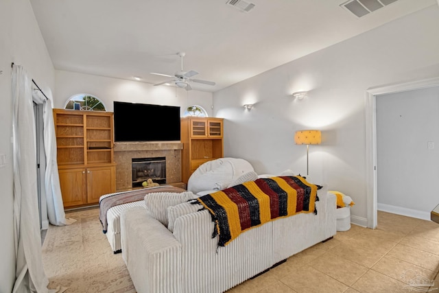 5140 Grumann Dr, Pensacola, FL 32507 - living area with ceiling fan, baseboards, a glass covered fireplace, and light tile patterned floors