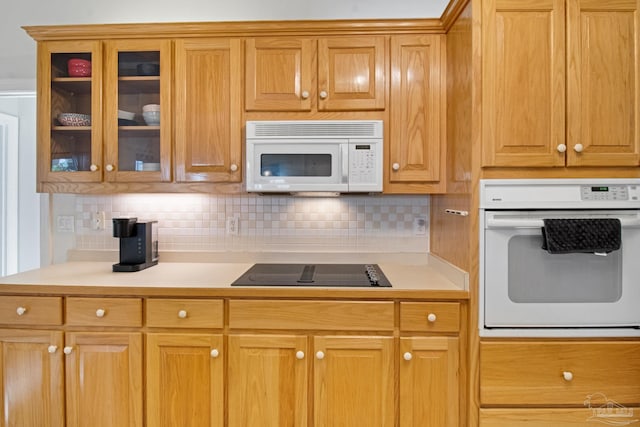5140 Grumann Dr, Pensacola, FL 32507 - kitchen featuring white appliances, light countertops, backsplash, and glass insert cabinets