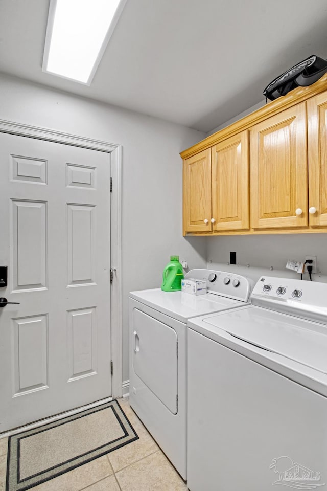 5140 Grumann Dr, Pensacola, FL 32507 - laundry room with cabinet space, washer and dryer, and light tile patterned flooring