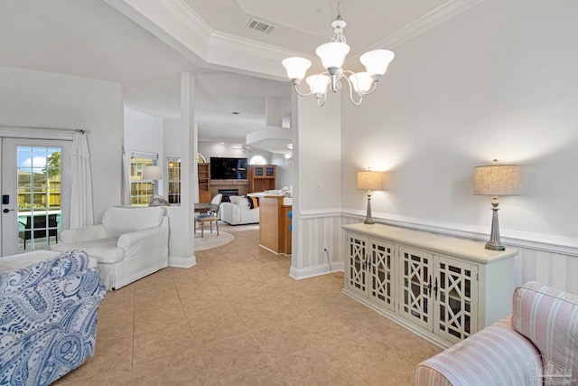 5140 Grumann Dr, Pensacola, FL 32507 - sitting room with a chandelier, a wainscoted wall, light tile patterned flooring, crown molding, and a raised ceiling