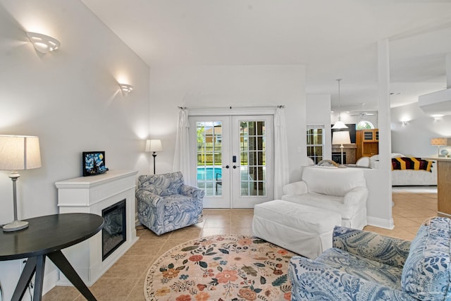 5140 Grumann Dr, Pensacola, FL 32507 - living area with french doors, light tile patterned floors, and a glass covered fireplace